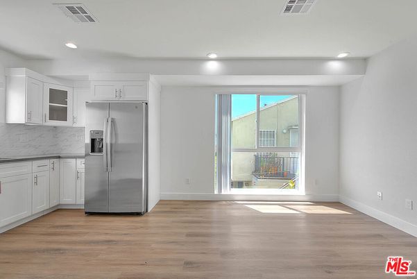 Empty room, Interior, Kitchen, Recessed Lighting, Stainless Steel Appliances, Wood Texture Flooring