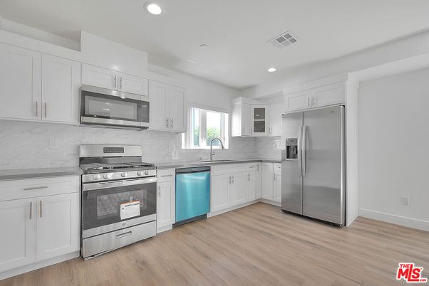 Interior, Kitchen, Marble Walls, Recessed Lighting, Stainless Steel Appliances, Wood Texture Flooring