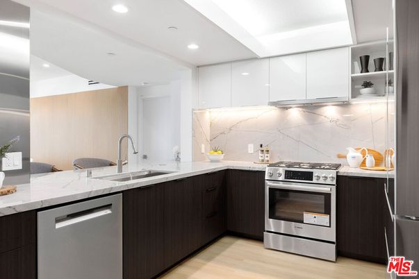 Interior, Kitchen, Marble Walls, Recessed Lighting, Stainless Steel Appliances, Wood Texture Flooring