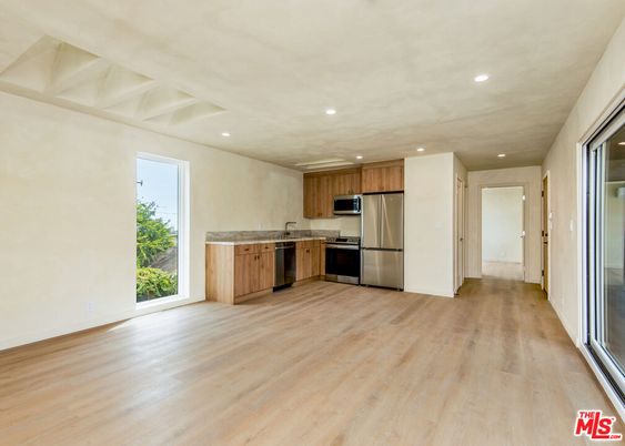 Empty room, Interior, Kitchen, Recessed Lighting, Stainless Steel Appliances, Wood Texture Flooring