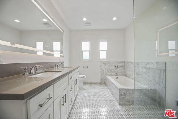 Bathroom, Dual Sink Vanities, Glass Shower, Interior, Marble Walls, Recessed Lighting