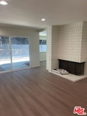 Empty room, Fireplace, Interior, Recessed Lighting, Stone Walls, Wood Texture Flooring