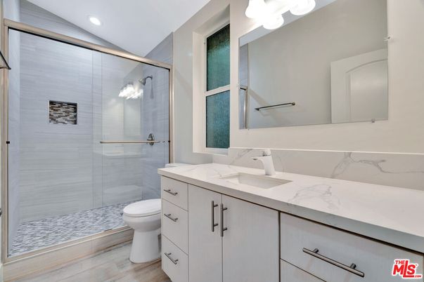 Bathroom, Dual Sink Vanities, Glass Shower, Interior, Recessed Lighting, Wood Texture Flooring