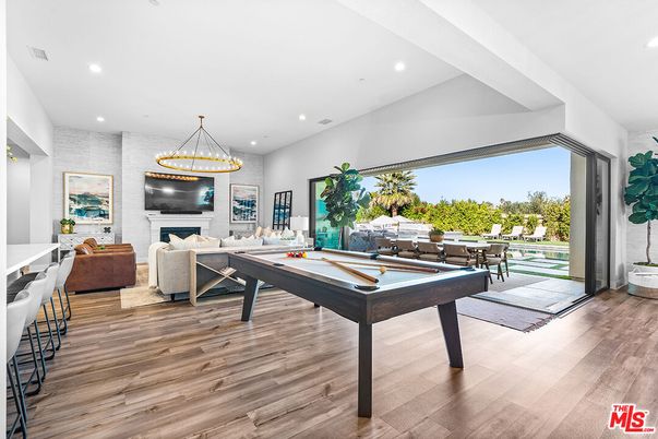 Billiard Table, Fireplace, Game Room, Interior, Living room, Pendant Lights, Recessed Lighting, Wood Texture Flooring