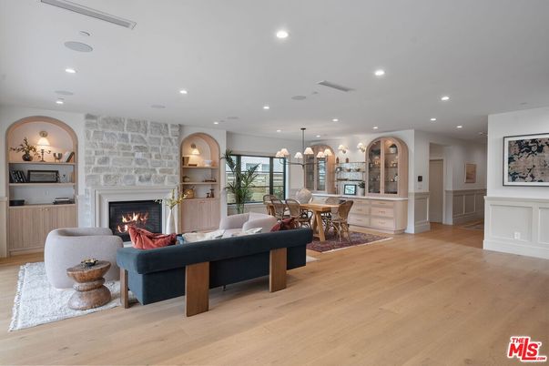 Chandelier, Dining room, Fireplace, Interior, Living room, Pendant Lights, Recessed Lighting, Stone Walls, Wood Texture Flooring