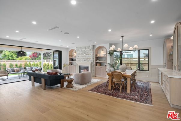 Chandelier, Dining room, Fireplace, Interior, Living room, Pendant Lights, Recessed Lighting, Wood Texture Flooring