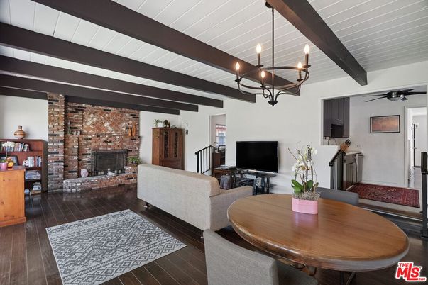 Chandelier, Dining room, Fireplace, Interior, Living room, Stone Walls, Wooden Beams, Wood Texture Flooring