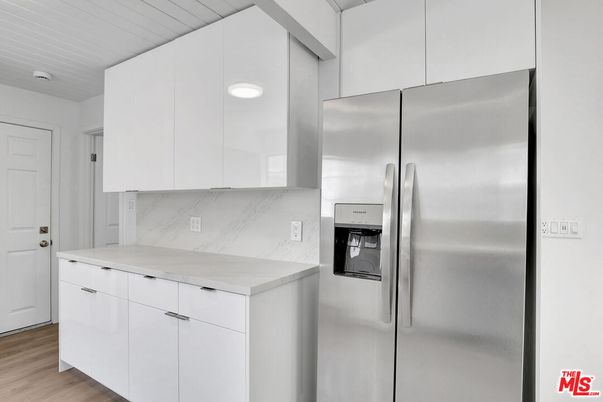 Interior, Kitchen, Marble Walls, Recessed Lighting, Stainless Steel Appliances, Wood Texture Flooring