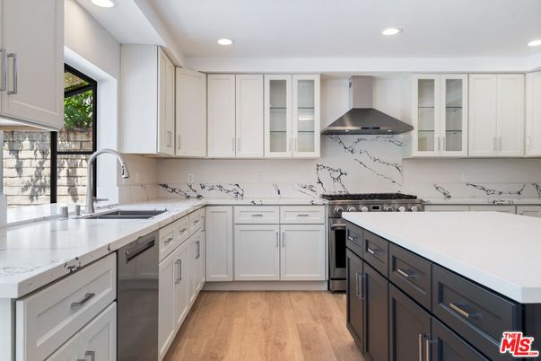 Interior, Kitchen, Marble Walls, Recessed Lighting, Stainless Steel Appliances, Wood Texture Flooring