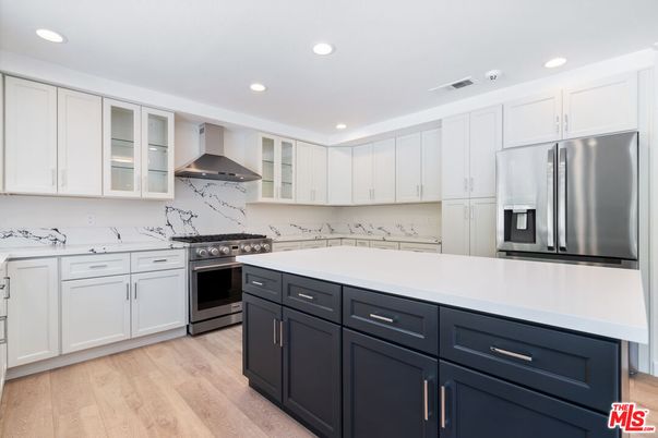 Interior, Kitchen, Marble Walls, Recessed Lighting, Stainless Steel Appliances, Wood Texture Flooring