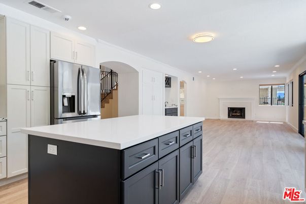 Fireplace, Interior, Kitchen, Recessed Lighting, Stainless Steel Appliances, Wood Texture Flooring