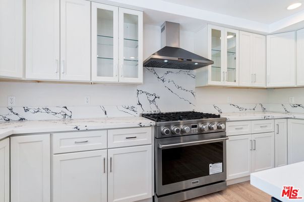 Interior, Kitchen, Marble Walls, Recessed Lighting, Stainless Steel Appliances, Wood Texture Flooring