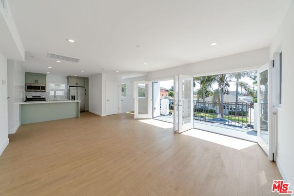 Empty room, Interior, Kitchen, Recessed Lighting, Stainless Steel Appliances, Wood Texture Flooring