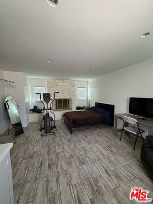 Bedroom, Fireplace, Fitness Equipment, Interior, Recessed Lighting, Wood Texture Flooring