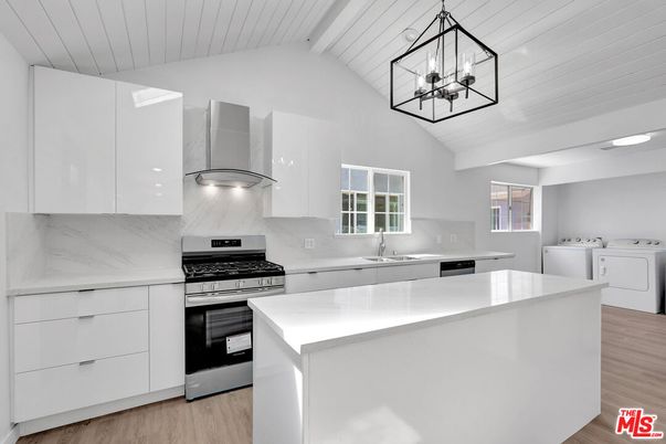 Interior, Kitchen, Marble Walls, Pendant Lights, Stainless Steel Appliances, Washer, Wood Texture Flooring