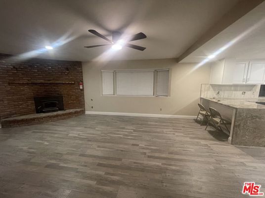 Empty room, Fireplace, Interior, Recessed Lighting, Stone Walls, Wood Texture Flooring