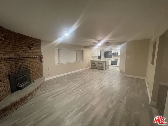 Empty room, Fireplace, Interior, Recessed Lighting, Stone Walls, Wood Texture Flooring