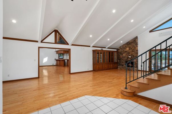 Empty room, Fireplace, Interior, Recessed Lighting, Stone Walls, Wood Texture Flooring