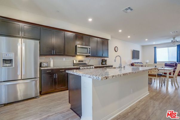 Dining room, Interior, Kitchen, Recessed Lighting, Stainless Steel Appliances, Wood Texture Flooring