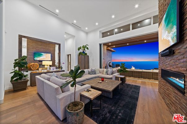 Fireplace, Interior, Living room, Recessed Lighting, Stone Walls, Water, Wood Texture Flooring
