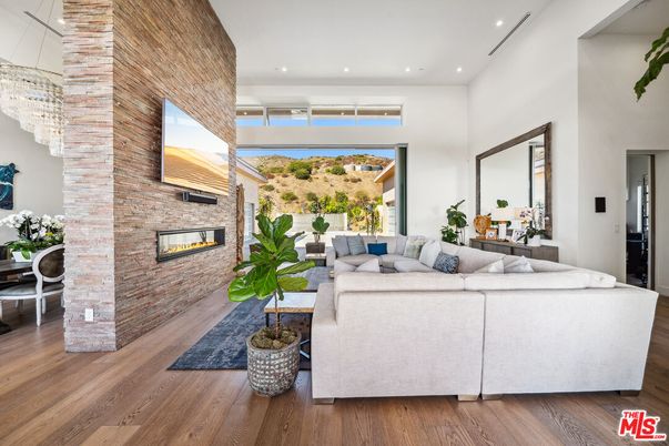 Fireplace, Interior, Living room, Recessed Lighting, Stone Walls, Wood Texture Flooring