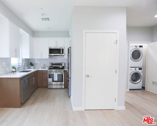 Interior, Kitchen, Recessed Lighting, Stainless Steel Appliances, Washer, Wood Texture Flooring