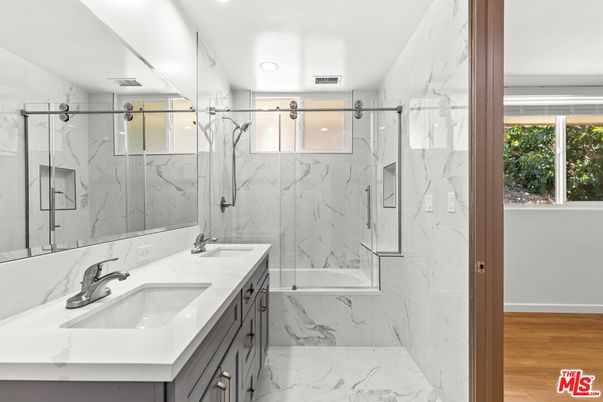 Bathroom, Dual Sink Vanities, Glass Shower, Interior, Marble, Marble Walls, Recessed Lighting, Wood Texture Flooring