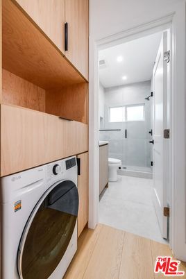 Bathroom, Glass Shower, Interior, Recessed Lighting, Washer, Wood Texture Flooring