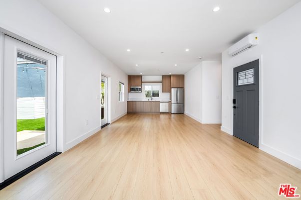 Empty room, Interior, Kitchen, Recessed Lighting, Stainless Steel Appliances, Wood Texture Flooring