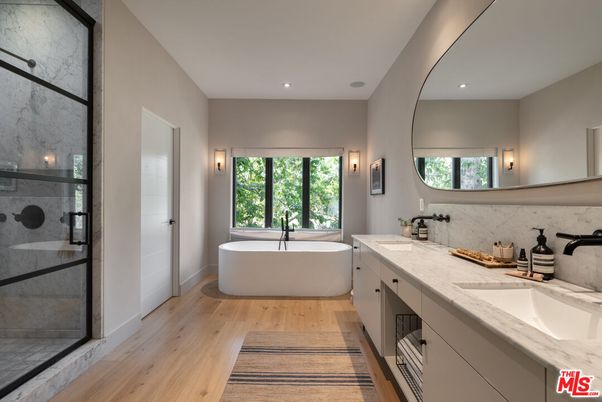 Bathroom, Dual Sink Vanities, Free Standing Baths, Glass Shower, Interior, Marble Walls, Recessed Lighting, Wood Texture Flooring