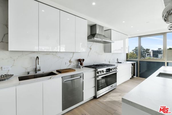 Interior, Kitchen, Marble Walls, Recessed Lighting, Stainless Steel Appliances, Wood Texture Flooring