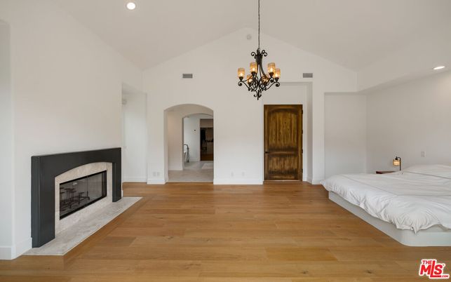 Bedroom, Chandelier, Fireplace, Interior, Recessed Lighting, Wood Texture Flooring