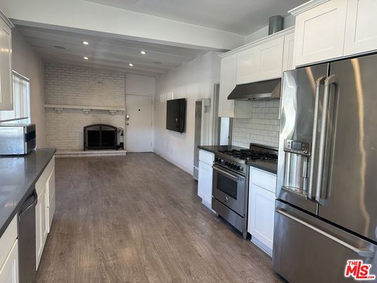 Fireplace, Interior, Kitchen, Recessed Lighting, Stainless Steel Appliances, Stone Walls, Wood Texture Flooring