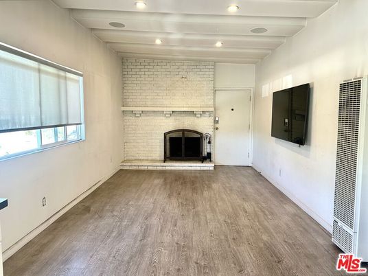 Empty room, Fireplace, Interior, Recessed Lighting, Stone Walls, Wood Texture Flooring