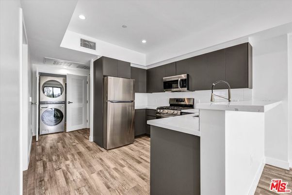 Interior, Kitchen, Recessed Lighting, Stainless Steel Appliances, Washer, Wood Texture Flooring