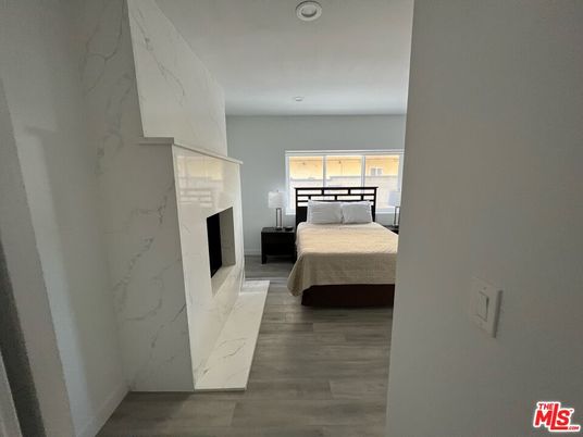 Bedroom, Fireplace, Interior, Marble Walls, Recessed Lighting, Wood Texture Flooring