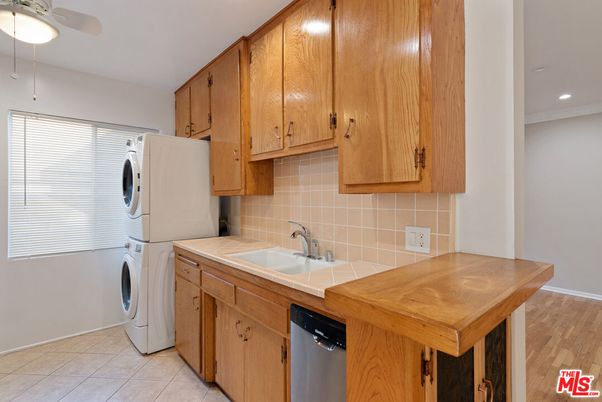 Interior, Kitchen, Recessed Lighting, Tile Countertops, Washer, Wood Texture Flooring