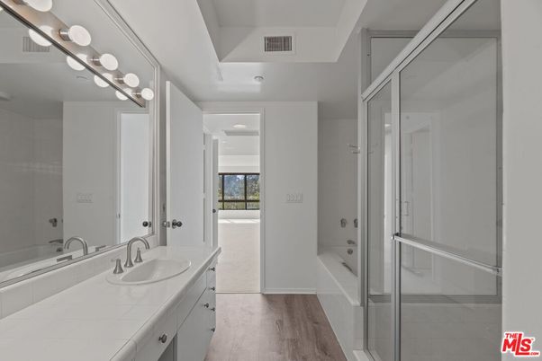 Bathroom, Dual Sink Vanities, Glass Shower, Interior, Tile Countertops, Wood Texture Flooring