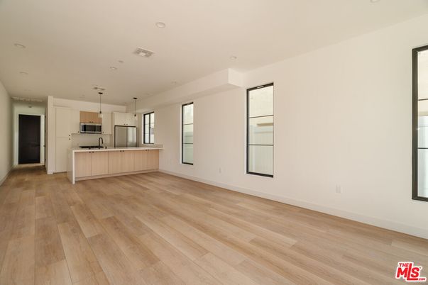 Empty room, Interior, Kitchen, Pendant Lights, Recessed Lighting, Stainless Steel Appliances, Wood Texture Flooring