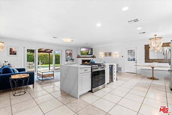 Chandelier, Fireplace, Interior, Kitchen, Living room, Recessed Lighting, Stainless Steel Appliances
