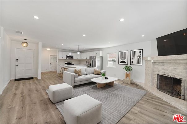 Fireplace, Interior, Kitchen, Living room, Pendant Lights, Recessed Lighting, Stainless Steel Appliances, Wood Texture Flooring