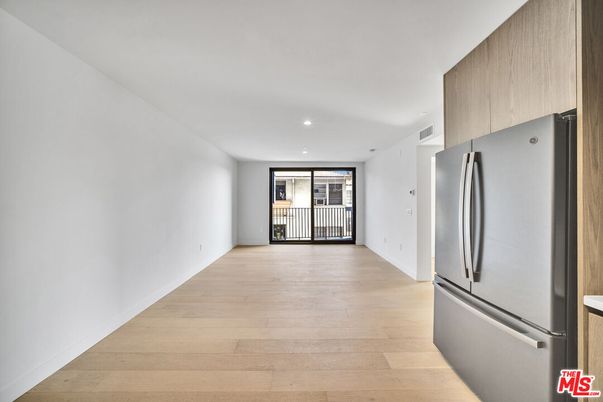 Empty room, Interior, Kitchen, Recessed Lighting, Stainless Steel Appliances, Wood Texture Flooring