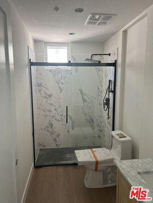 Bathroom, Glass Shower, Interior, Marble Walls, Recessed Lighting, Wood Texture Flooring