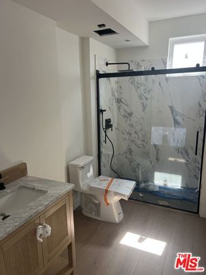 Bathroom, Glass Shower, Interior, Marble Walls, Wood Texture Flooring