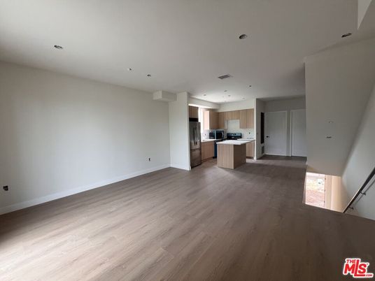Empty room, Interior, Kitchen, Recessed Lighting, Stainless Steel Appliances, Wood Texture Flooring