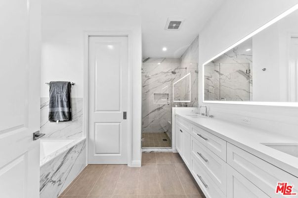 Bathroom, Dual Sink Vanities, Glass Shower, Interior, Marble Walls, Recessed Lighting, Wood Texture Flooring