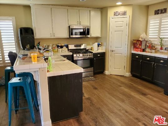 Interior, Kitchen, Recessed Lighting, Stainless Steel Appliances, Tile Countertops, Wood Texture Flooring