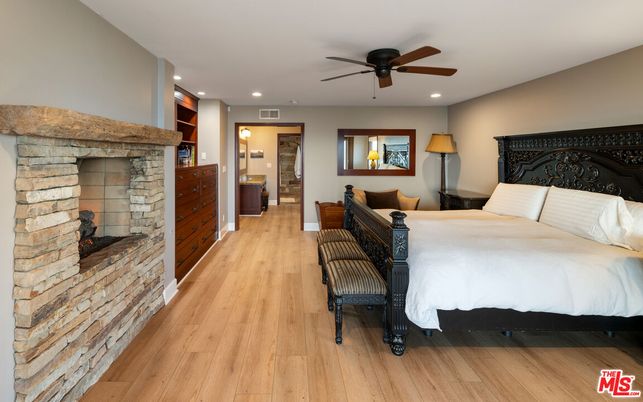 Bedroom, Fireplace, Interior, Recessed Lighting, Stone Walls, Wood Texture Flooring