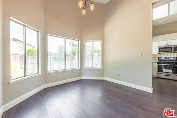 Empty room, Interior, Kitchen, Pendant Lights, Stainless Steel Appliances, Wood Texture Flooring