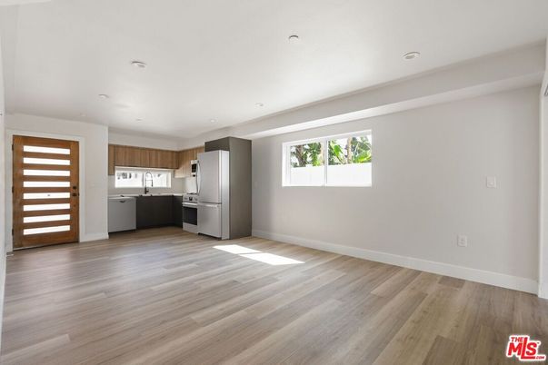 Empty room, Interior, Kitchen, Recessed Lighting, Stainless Steel Appliances, Wood Texture Flooring
